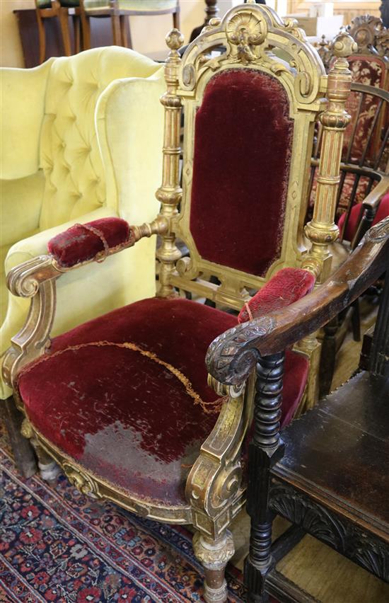 A Victorian carved oak and gilt elbow chair
